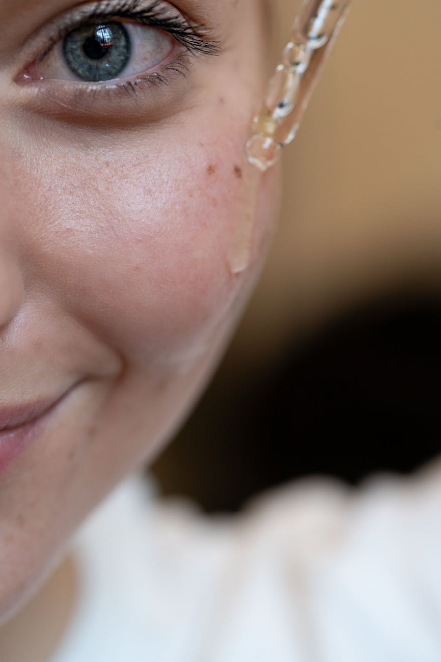 close up of skincare serum application on face
