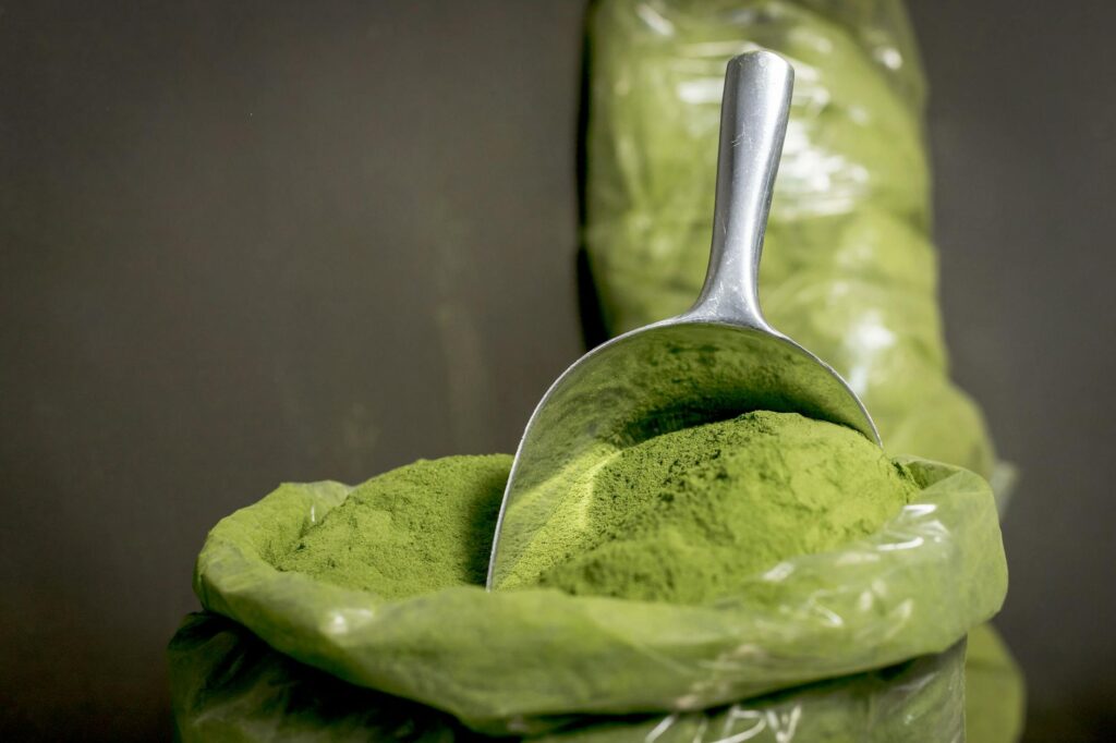 stainless spoon with green powder